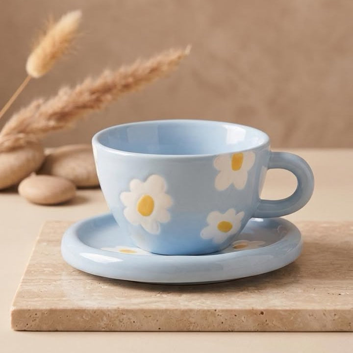 TAZA AZUL CON FLORES BLANCAS