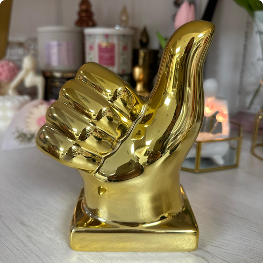 FIGURA DECORATIVA MANITO PULGAR DORADA