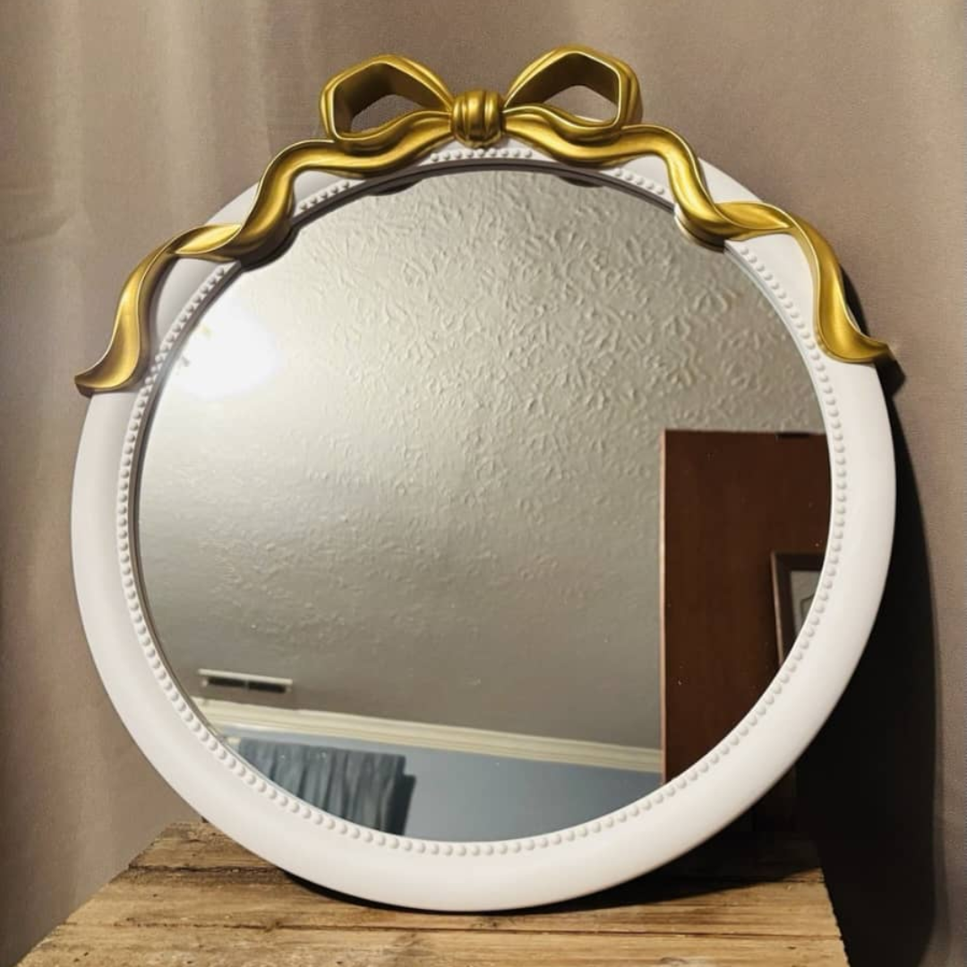 ESPEJO REDONDO CON LAZO DORADO ENCIMA